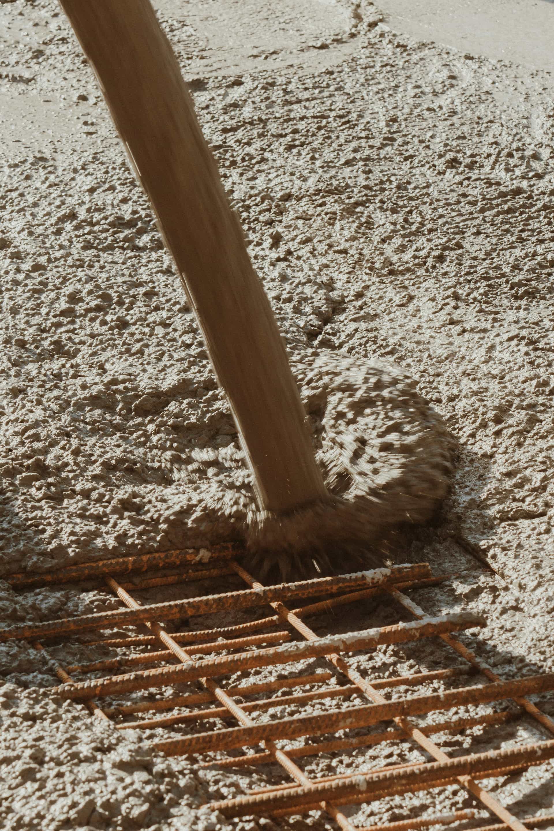 Concrete running down a truck chute onto a rebar grid
